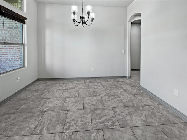 unfurnished dining area with a notable chandelier