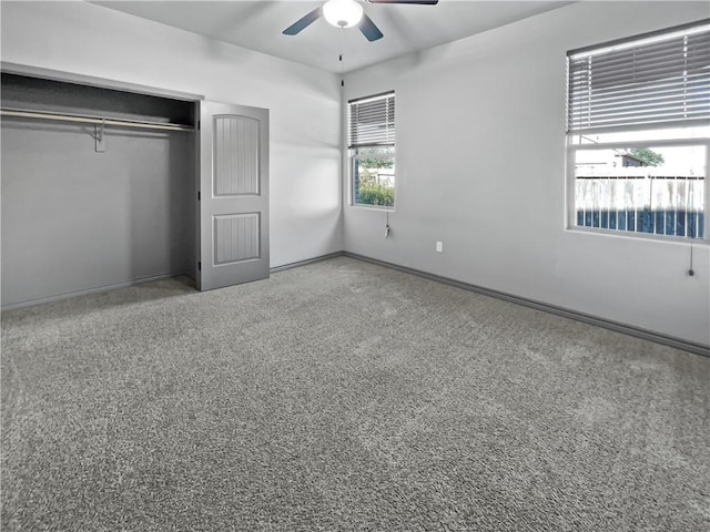 unfurnished bedroom featuring carpet flooring, ceiling fan, and a closet