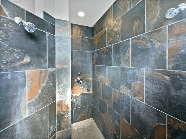 interior details featuring a tile shower