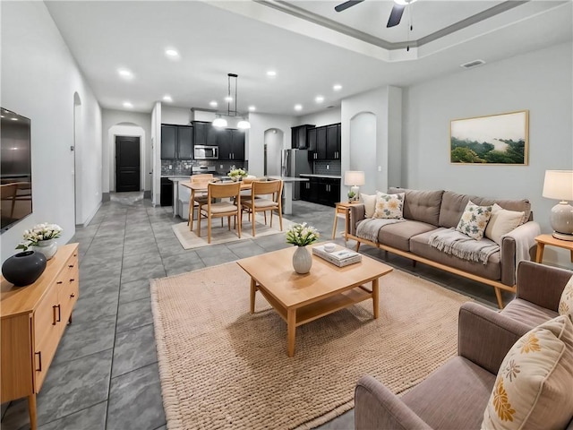 tiled living room featuring ceiling fan