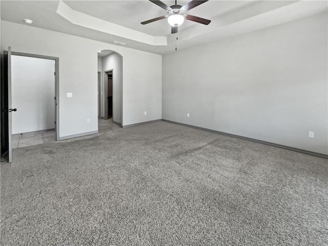 spare room featuring ceiling fan and a tray ceiling