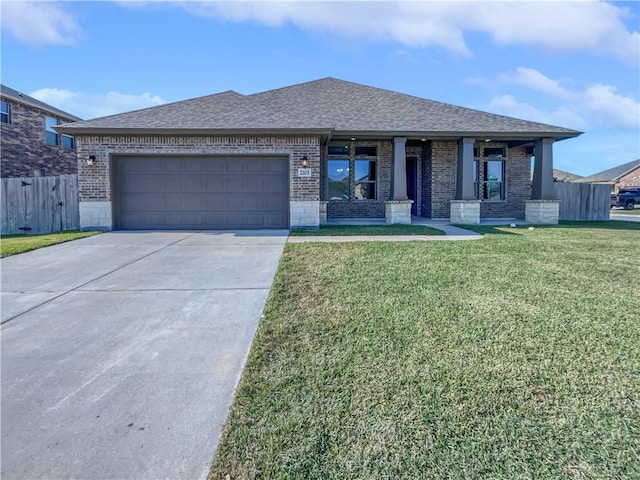 view of front of house with a front yard and a garage