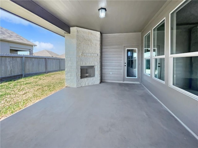 view of patio / terrace featuring an outdoor stone fireplace