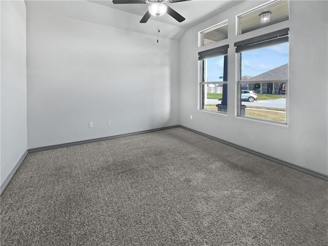 carpeted empty room featuring ceiling fan and vaulted ceiling