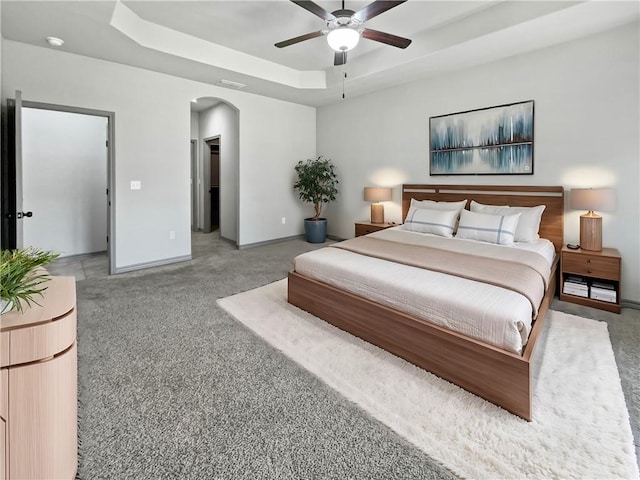 bedroom featuring a tray ceiling and ceiling fan