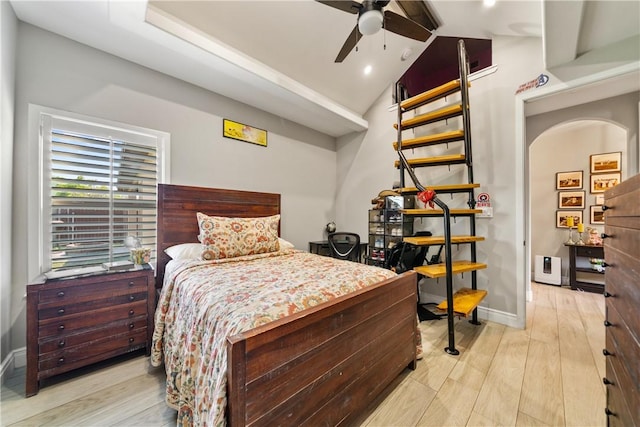 bedroom with baseboards, vaulted ceiling, and wood finished floors