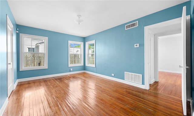 empty room with hardwood / wood-style flooring