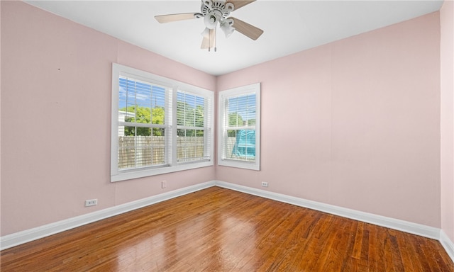 spare room with hardwood / wood-style flooring and ceiling fan