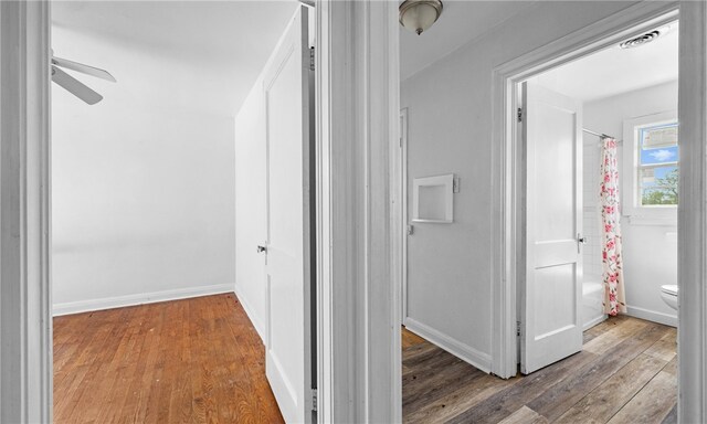 hallway with light hardwood / wood-style floors