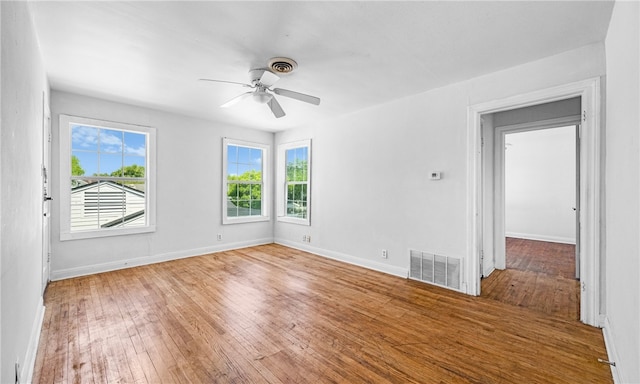 spare room featuring wood-type flooring and ceiling fan