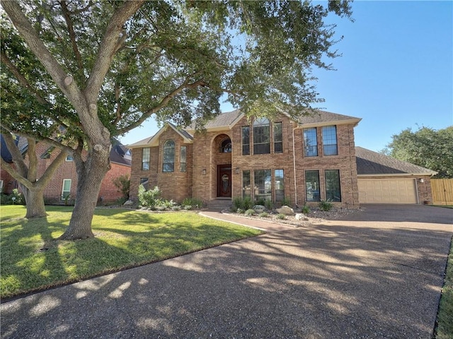 view of front facade featuring a front yard and a garage