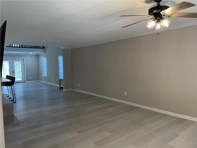 7029 Tamarron Ct, Corpus Christi, TX 78413 - empty room featuring light wood-style floors, baseboards, french doors, a ceiling fan, and crown molding