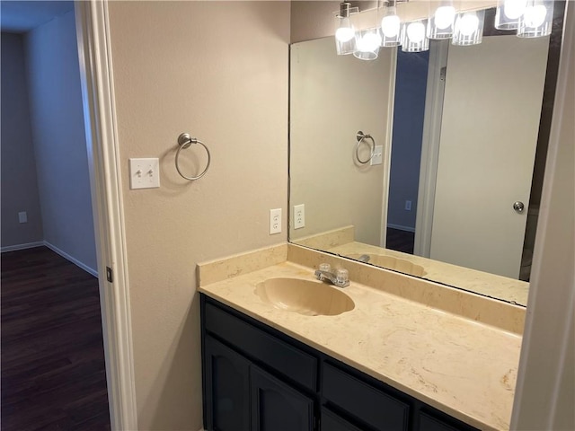 7029 Tamarron Ct, Corpus Christi, TX 78413 - bathroom featuring vanity, wood finished floors, and baseboards