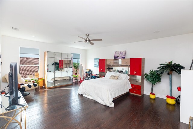 bedroom with ceiling fan and dark hardwood / wood-style floors