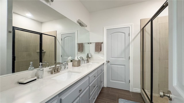 bathroom with vanity and a shower with door