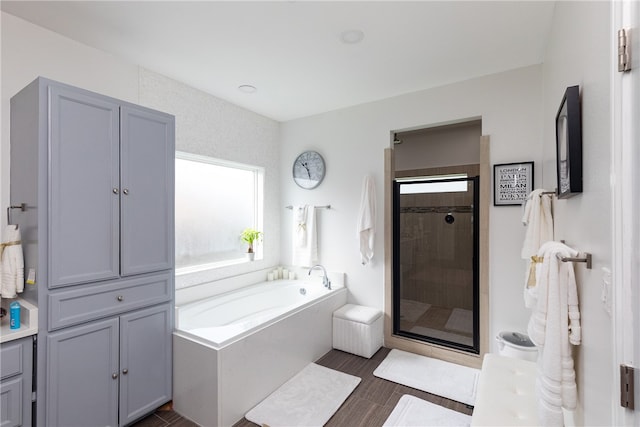 bathroom featuring independent shower and bath