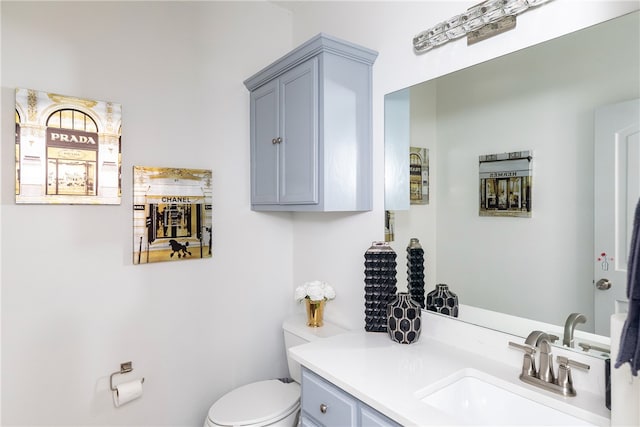 bathroom featuring toilet and vanity