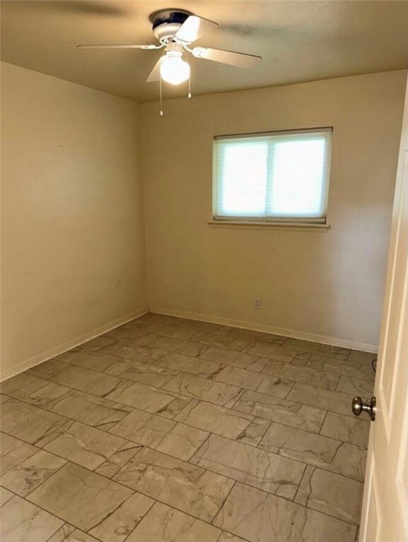 unfurnished room featuring ceiling fan