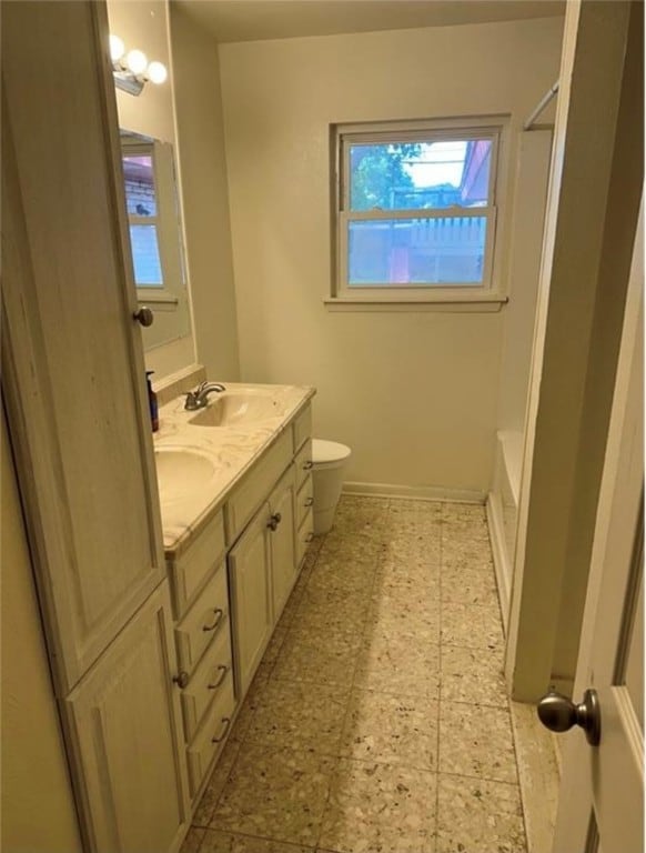 bathroom featuring walk in shower, vanity, and toilet