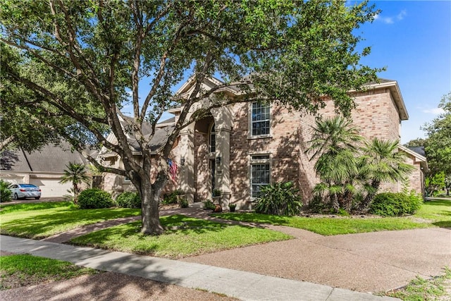 7601 Dijon Lake Dr, Corpus Christi, TX 78413 - view of front facade featuring a front lawn and brick siding