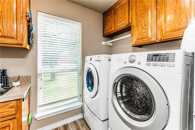 7601 Dijon Lake Dr, Corpus Christi, TX 78413 - washroom with independent washer and dryer, cabinet space, and wood finished floors