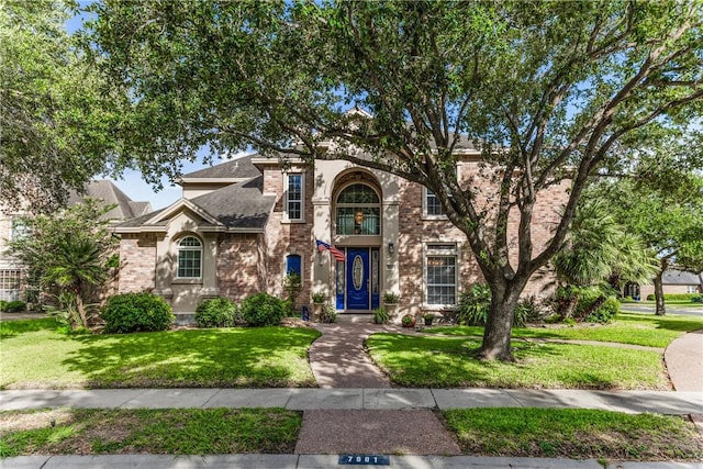 7601 Dijon Lake Dr, Corpus Christi, TX 78413 - traditional-style home with brick siding, a front lawn, and roof with shingles