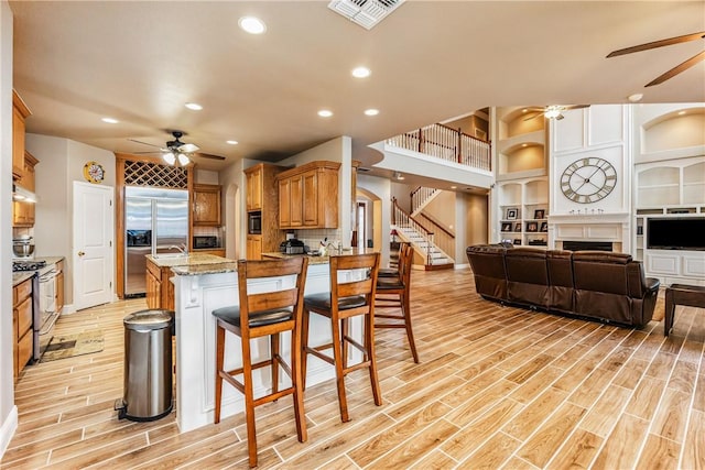 7601 Dijon Lake Dr, Corpus Christi, TX 78413 - kitchen with ceiling fan, open floor plan, light wood-style floors, recessed lighting, and appliances with stainless steel finishes