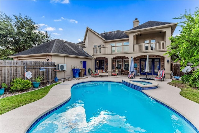 7601 Dijon Lake Dr, Corpus Christi, TX 78413 - rear view of house featuring french doors, a balcony, a patio, stucco siding, and a fenced backyard
