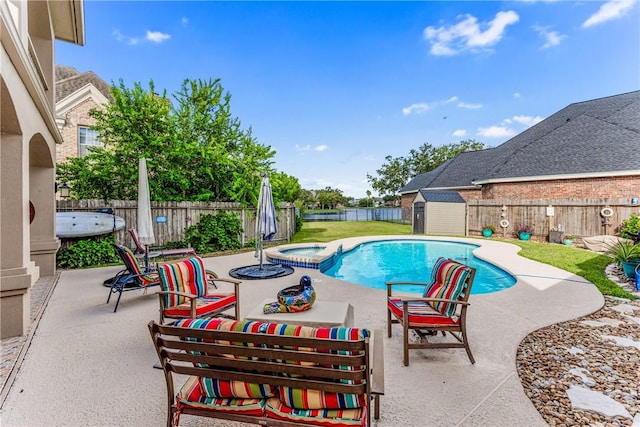 7601 Dijon Lake Dr, Corpus Christi, TX 78413 - view of pool with a patio, a storage unit, a fenced backyard, and a pool with connected hot tub