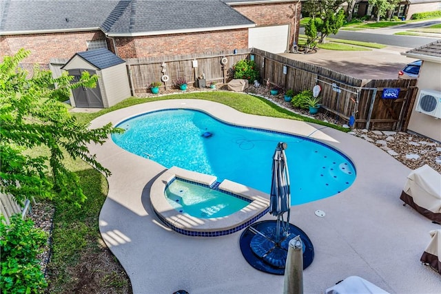 7601 Dijon Lake Dr, Corpus Christi, TX 78413 - view of swimming pool with a shed, a fenced backyard, and a pool with connected hot tub