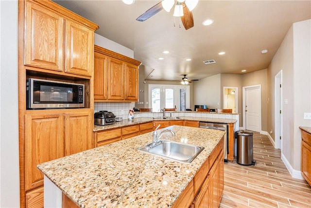 7601 Dijon Lake Dr, Corpus Christi, TX 78413 - kitchen with a ceiling fan, a peninsula, recessed lighting, light wood-type flooring, and stainless steel appliances