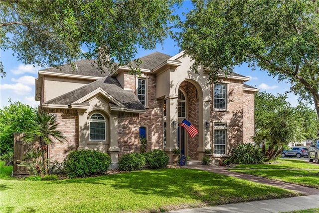 7601 Dijon Lake Dr, Corpus Christi, TX 78413 - traditional-style house featuring roof with shingles, a front yard, and brick siding