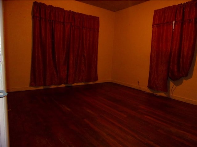 spare room featuring wood-type flooring