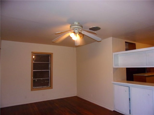 empty room featuring ceiling fan and dark wood-type flooring