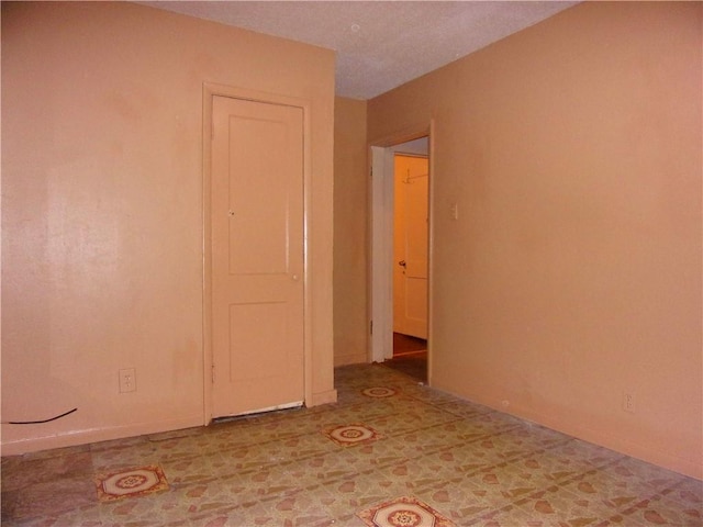 unfurnished room featuring a textured ceiling