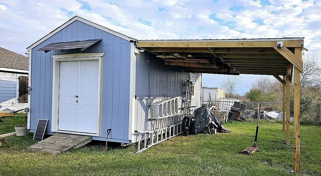 view of outbuilding with a lawn