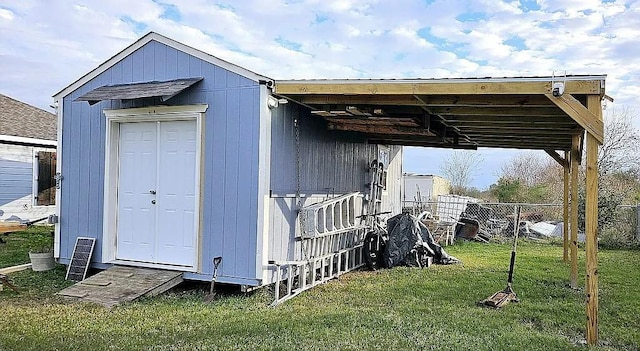 view of outbuilding with a lawn