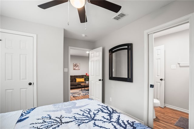 bedroom with ceiling fan and wood-type flooring