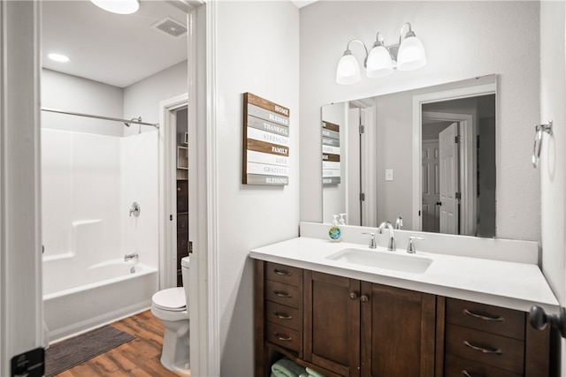 full bathroom featuring  shower combination, wood-type flooring, vanity, and toilet