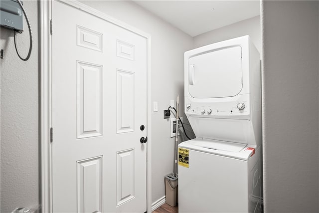 laundry room with stacked washing maching and dryer