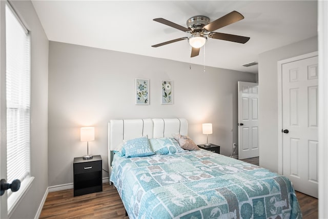 bedroom with dark wood-type flooring, ceiling fan, and multiple windows