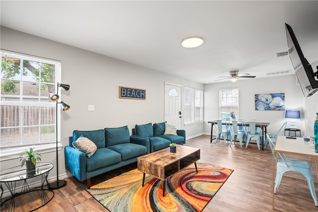 living room featuring hardwood / wood-style flooring and ceiling fan