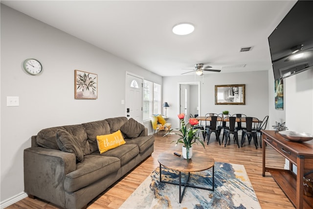 living room with hardwood / wood-style flooring and ceiling fan