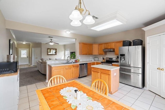 7558 Angelwing Dr, Corpus Christi, TX 78414 - kitchen with light countertops, light tile patterned floors, a sink, open floor plan, and stainless steel appliances