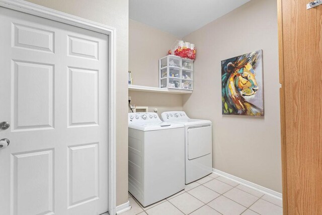 7558 Angelwing Dr, Corpus Christi, TX 78414 - washroom featuring baseboards, light tile patterned floors, laundry area, and washer and clothes dryer