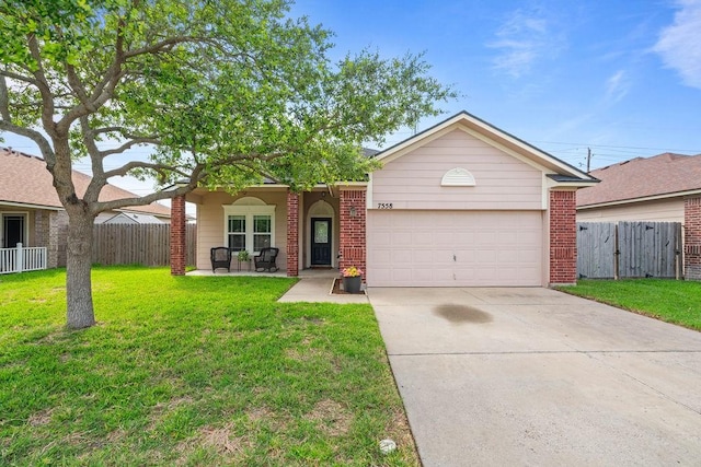 7558 Angelwing Dr, Corpus Christi, TX 78414 - view of front of house featuring fence, an attached garage, driveway, and a front yard