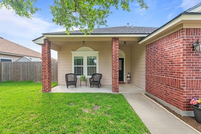 7558 Angelwing Dr, Corpus Christi, TX 78414 - doorway to property with a lawn, fence, brick siding, and a patio