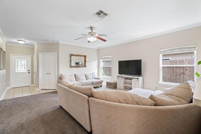 7558 Angelwing Dr, Corpus Christi, TX 78414 - living area featuring ceiling fan, light colored carpet, crown molding, visible vents, and light tile patterned flooring