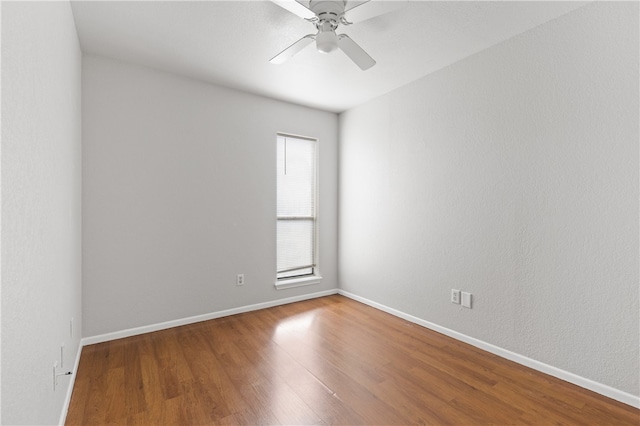 empty room featuring hardwood / wood-style flooring and ceiling fan