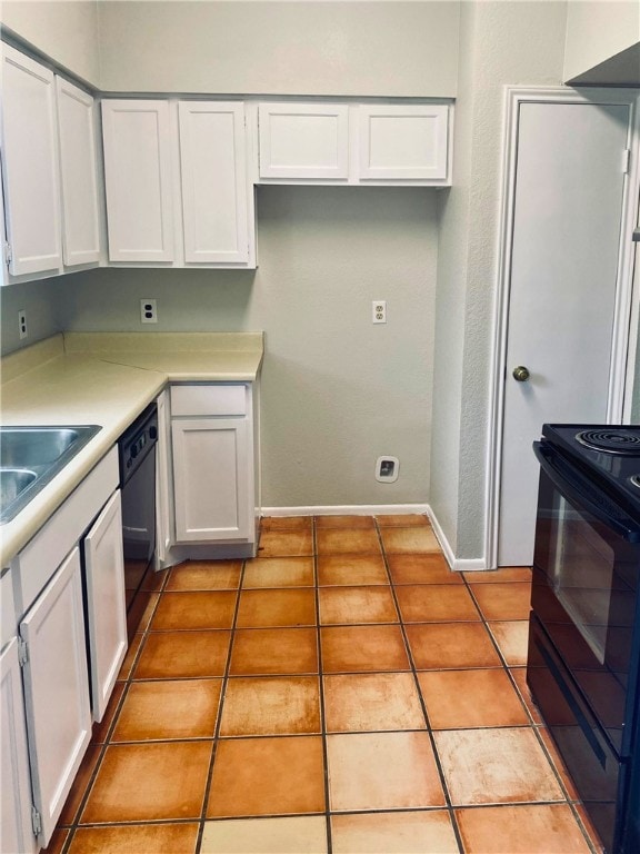 kitchen featuring light tile patterned floors, black appliances, sink, and white cabinets